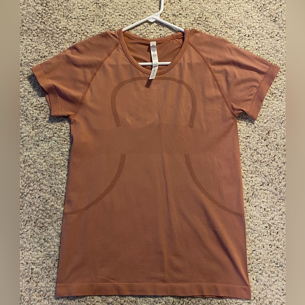Pink size 10 Lululemon dupe Swiftly Tech t-shit with Lulu logo.